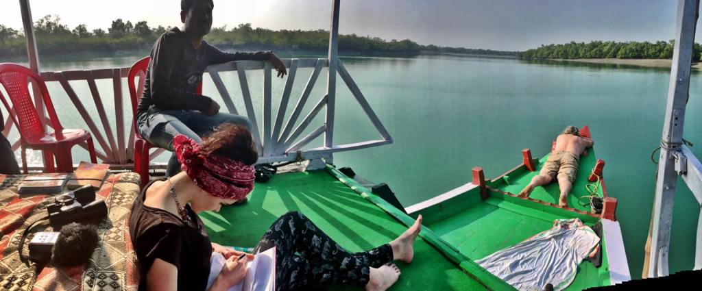  Nat writing poetry on a boat in India